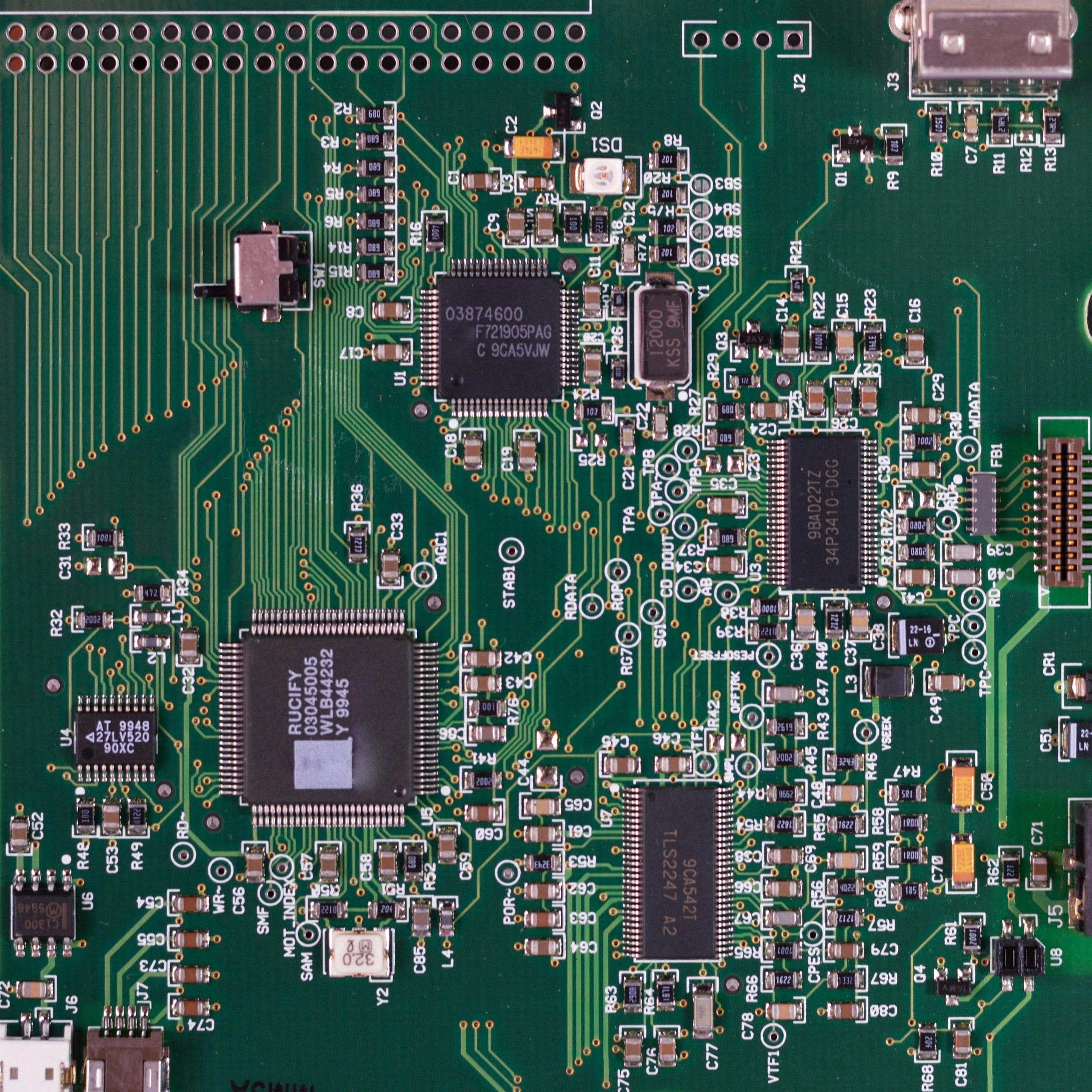 Detailed image of a green circuit board featuring various components and microprocessors.